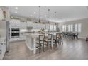 Spacious open kitchen with a large island, breakfast bar, and adjacent dining area at 3466 E Hazeltine Way, Queen Creek, AZ 85142