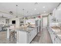Well-lit kitchen featuring a center island, stainless appliances, and open floor plan at 3466 E Hazeltine Way, Queen Creek, AZ 85142