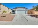 Charming single-story home featuring a well-manicured lawn, neutral paint, a two-car garage and a concrete driveway at 11822 W Softwind Dr, Sun City, AZ 85373