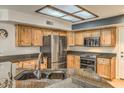 Updated kitchen featuring stainless steel appliances, granite countertops, and knotty alder cabinets at 15846 S 33Rd Pl, Phoenix, AZ 85048
