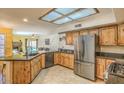 Open concept kitchen featuring granite countertops, stainless appliances, and abundant cabinetry at 15846 S 33Rd Pl, Phoenix, AZ 85048