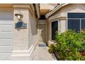 Inviting front entryway with security screen door, textured walls, and a decorative address number at 16642 N 35Th Way, Phoenix, AZ 85032