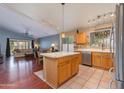 Open kitchen featuring a center island, stainless steel appliances, and a view into the living area at 16642 N 35Th Way, Phoenix, AZ 85032