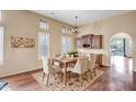 Charming dining room with a table set for six, complemented by a unique floral rug at 3054 W Eagle Claw Dr, Phoenix, AZ 85086
