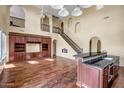 Open living area with high ceilings, hardwood floors, custom cabinetry, and a staircase at 3054 W Eagle Claw Dr, Phoenix, AZ 85086