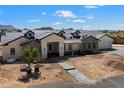Charming home with dormer windows, paver driveway, and white and stone facade at 3323 N 81St St, Mesa, AZ 85207