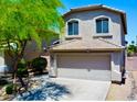 Charming two-story home boasts a neutral facade, two-car garage, and well-maintained landscaping at 4712 E Amberwood Dr, Phoenix, AZ 85048