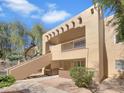 Attractive condo exterior with a staircase leading to a balcony and desert landscaping at 500 N Gila Springs Blvd # 230, Chandler, AZ 85226