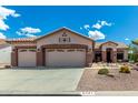 Charming single-story home with a three-car garage and desert landscaping at 5381 S Emerald Desert Dr, Gold Canyon, AZ 85118