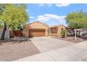 Charming single-story home featuring a two-car garage and desert landscaping at 5408 W Allen St, Laveen, AZ 85339
