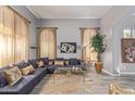 Bright living room featuring a gray sectional sofa, decorative pillows, and an animal print rug at 7162 W Lone Cactus Dr, Glendale, AZ 85308