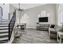 Spacious living room featuring high ceilings, wood floors, and modern staircase at 7642 E Sandia Cir, Mesa, AZ 85207