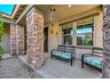 Cozy front porch with stone pillars, seating area, and decorative details, enhancing the entrance at 7773 W Adam Ave, Peoria, AZ 85382