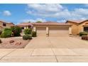 Charming home featuring a tile roof and a spacious three-car garage, complemented by lush landscaping at 9154 E Caribbean Ln, Scottsdale, AZ 85260