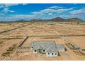 Wide aerial shot showing property, perimeter wall and desert landscape and mountain views at 9486 W Sandstone Mountain Dr, Casa Grande, AZ 85194