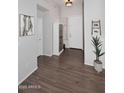 Inviting entryway featuring wood-look floors, a decorative cabinet, and neutral wall tones at 9827 N Desert Rose Dr, Fountain Hills, AZ 85268