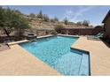 Sparkling pool with waterfall feature and desert landscaping at 9827 N Desert Rose Dr, Fountain Hills, AZ 85268
