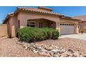 Inviting single-story home featuring desert landscaping, a two-car garage, and a charming covered porch at 12238 W Monroe St, Avondale, AZ 85323