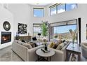 Bright living room boasts soaring ceilings, modern fireplace, and seamless indoor-outdoor flow to scenic patio at 13209 N 17Th Pl, Phoenix, AZ 85022