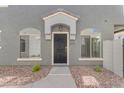 Stylish townhome entry featuring a dark-colored front door with a covered porch at 2402 E 5Th St # 1621, Tempe, AZ 85288