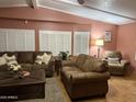 Relaxing living room area featuring brown sofas, stylish pillows, natural light, and an end table at 2763 N Wright Way, Mesa, AZ 85215