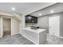 Well-lit kitchen with quartz countertops, dark cabinets, and stainless steel appliances, creating a modern cooking space at 30 E Brown Rd # 1048, Mesa, AZ 85201