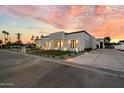 Beautiful modern home with stone accents, manicured lawn, and a stylish gated driveway at 6202 E Larkspur Dr, Scottsdale, AZ 85254