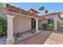 Inviting front entrance with stately columns, a red brick walkway, and well-manicured landscaping at 7917 E Cactus Wren Rd, Scottsdale, AZ 85250