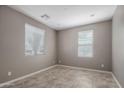 Bright living room with neutral paint, tile flooring, and natural light from two windows at 865 E Rojo Ct, Gilbert, AZ 85297