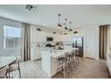 Modern kitchen with white cabinets, stainless appliances, and a center island at 10149 E Ursula Ave, Mesa, AZ 85212