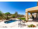 Private backyard featuring a pool, covered patio, desert landscaping, and outdoor seating area at 10287 E Verbena Ln, Scottsdale, AZ 85255