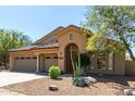Single-story home featuring a three-car garage, desert landscaping, and a welcoming front entrance at 10287 E Verbena Ln, Scottsdale, AZ 85255
