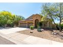 Inviting single-story home with desert landscaping, a three-car garage and plenty of curb appeal at 10287 E Verbena Ln, Scottsdale, AZ 85255