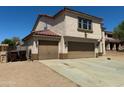 Two-story home featuring tan stucco, brown accents, and a spacious two-car garage at 10528 W Jessie Ln, Peoria, AZ 85383