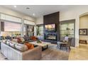 Spacious living room with sleek fireplace, display shelving, and luxurious furnishings at 10811 E Acoma Dr, Scottsdale, AZ 85255