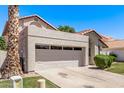Single-story home featuring a two-car garage, desert landscaping, and a red tile roof on a bright, clear day at 113 S Ocean Dr, Gilbert, AZ 85233