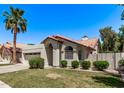 Single-story home with a two-car garage, desert landscaping, and a red tile roof on a sunny day at 113 S Ocean Dr, Gilbert, AZ 85233