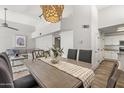 Open dining room with modern chandelier and views of living room at 11333 N 92Nd St # 2049, Scottsdale, AZ 85260