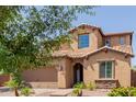 Home with a tile roof, two-car garage, and desert landscaping provides an inviting curb appeal at 11466 N 162Nd Ln, Surprise, AZ 85379
