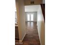 View of the living room with attractive wood-look floors, accessible through a welcoming hallway at 12245 N 21St Ave # 1, Phoenix, AZ 85029