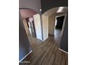 View of the kitchen, with stainless steel appliances, and arched doorways at 12422 N 121St Dr, El Mirage, AZ 85335