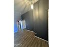 Open-concept living room with overhead lighting and wood-look flooring at 12422 N 121St Dr, El Mirage, AZ 85335