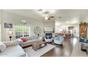 Open-concept living room featuring a fireplace, hardwood floors, and ample natural light at 139 W Granada Rd, Phoenix, AZ 85003