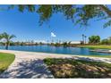 View of the lake with lush landscaping and a community dock at 1538 W Wagner Dr, Gilbert, AZ 85233