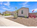 Exterior shot of a single-story home with desert landscaping, two-car garage and a concrete driveway at 18501 E Donato Dr, Gold Canyon, AZ 85118
