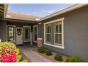 Charming entrance showcasing a welcoming door, sidelights, and colorful flowers that provide great curb appeal at 22670 E Russet Rd, Queen Creek, AZ 85142