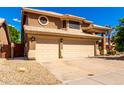 Charming two-story home with a three-car garage and a well-maintained yard with mature landscaping at 23829 N 59Th Dr, Glendale, AZ 85310