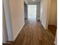 Spacious hallway featuring wood-style tile flooring and neutral wall colors at 25351 W Bowker St, Buckeye, AZ 85326