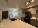 Kitchen featuring stainless appliances, stone countertops, gray cabinets, and a gold faucet at 2625 W Ocotillo Rd # 4, Phoenix, AZ 85017