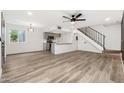 Open-concept living area featuring wood-look flooring, neutral paint, and a staircase leading to the upper level at 2625 W Ocotillo Rd # 4, Phoenix, AZ 85017